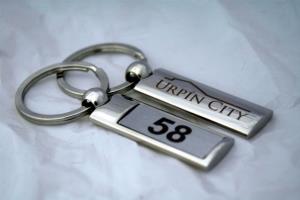 Kľúčenky s číslami izieb a logom hotela Urpín City